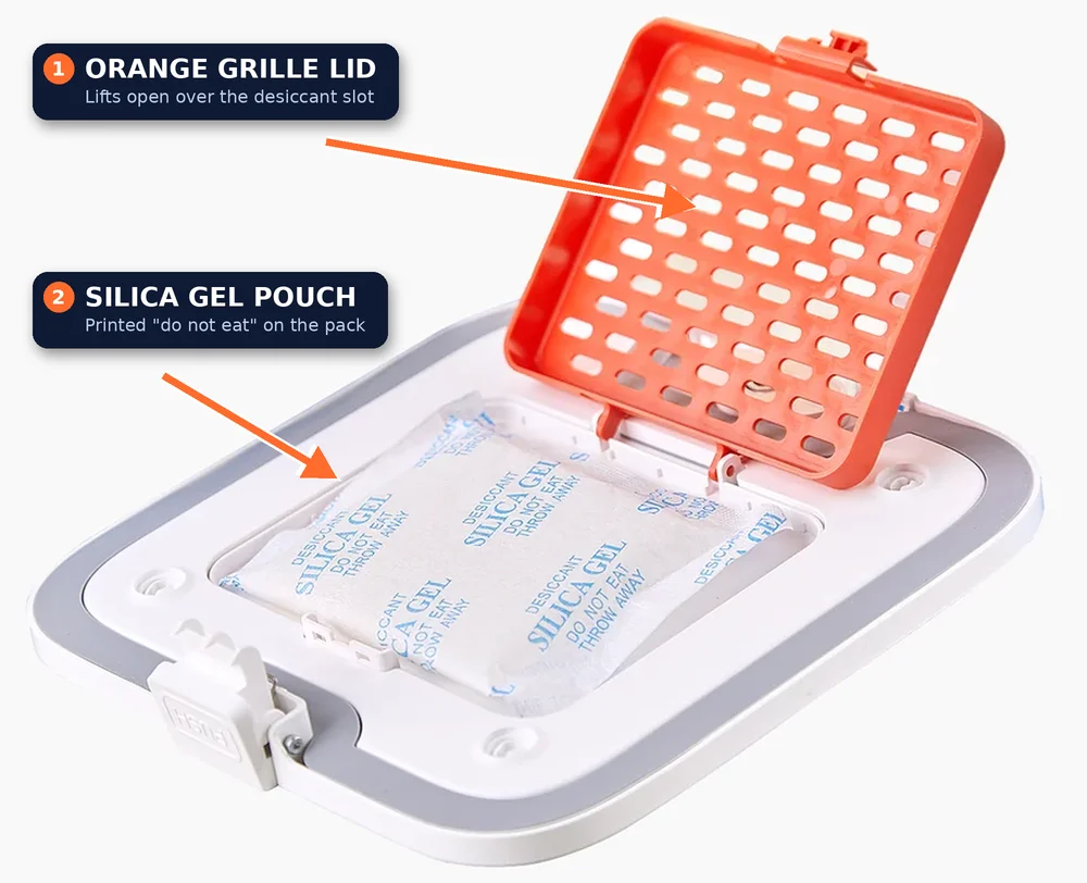 PETKIT feeder desiccant slot with the orange grille lid open and a silica gel pouch printed do not eat, labelled